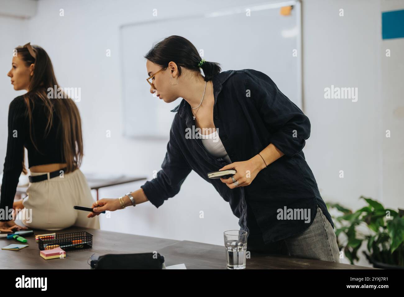 Students collaborating on school projects in a classroom setting Stock Photo