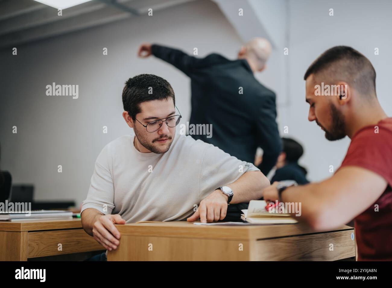 Engaged students collaborating during a classroom learning session Stock Photo