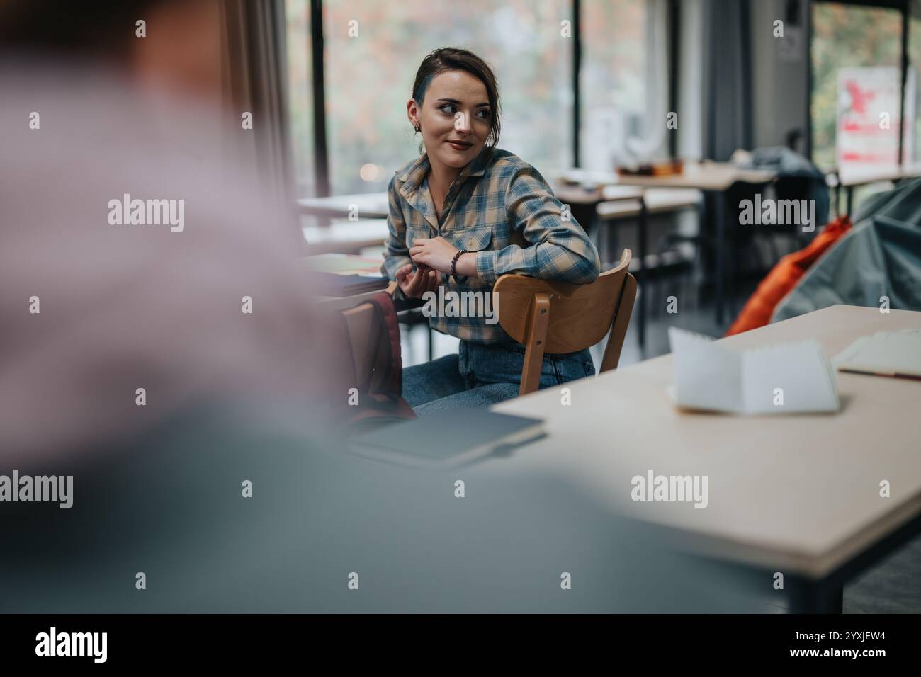 Student engaged in classroom discussion with peers Stock Photo