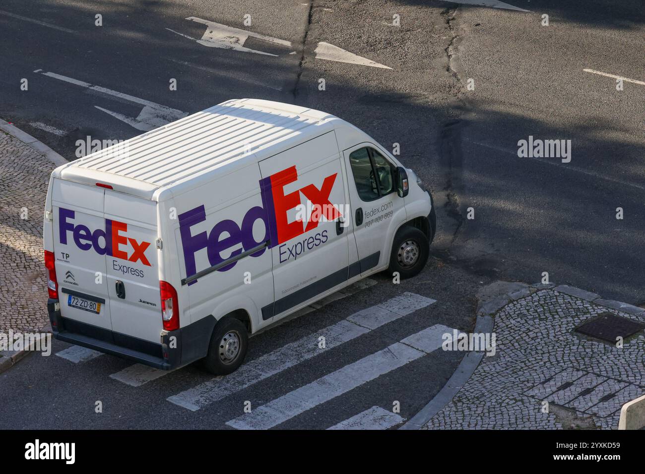 White fedex express delivery van parked on a city street, ready for shipping and logistics operations Stock Photo