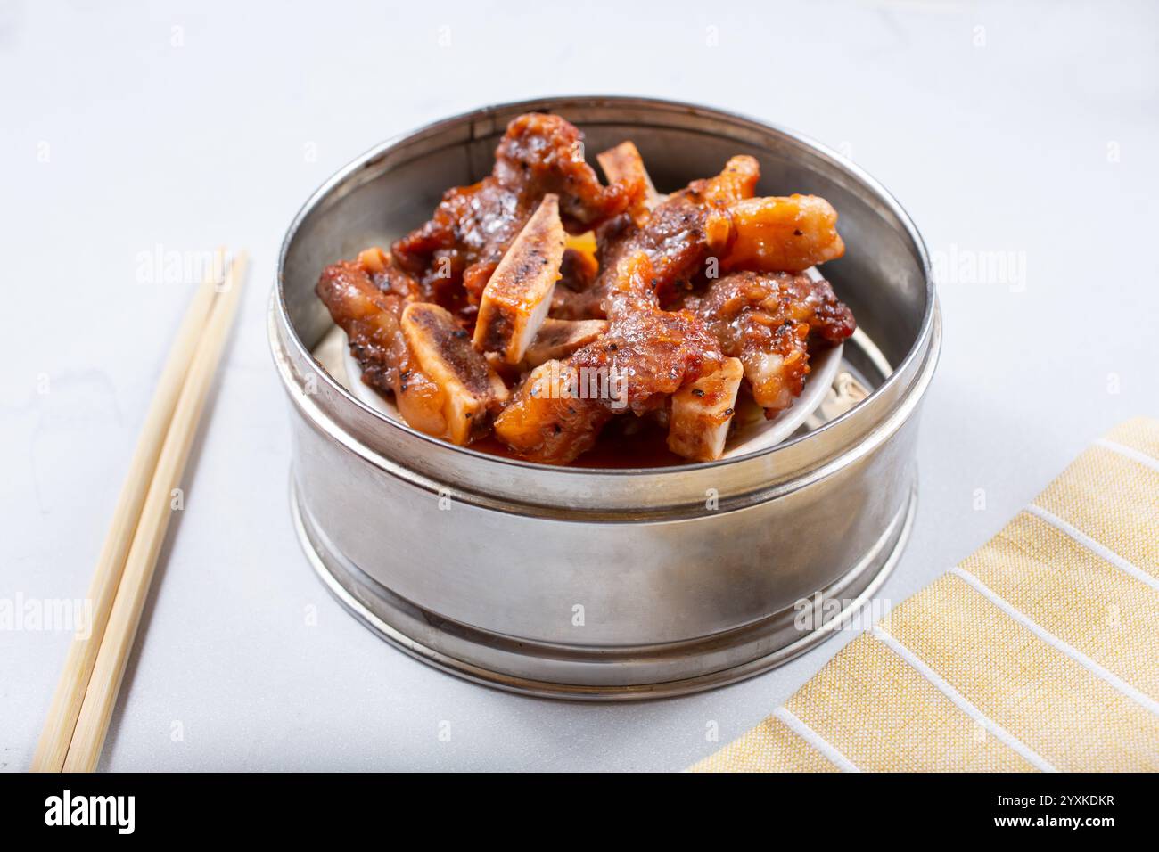 A view of a steamer container featuring beef short ribs Stock Photo - Alamy