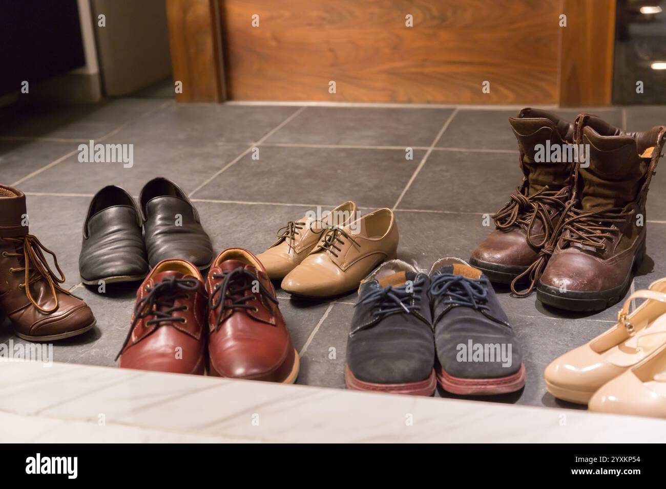 Entrance hallway lined with shoes Stock Photo