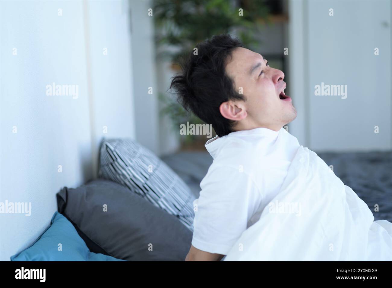 Man on bed Stock Photo - Alamy