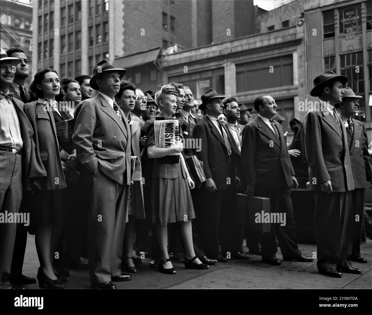 Invasion! Pedestrians watching news of the Normandy Invasion on an electric marquee near Times Square on D-Day, June 6, 1944. New York - Photo by Howard L. Hollem Stock Photo