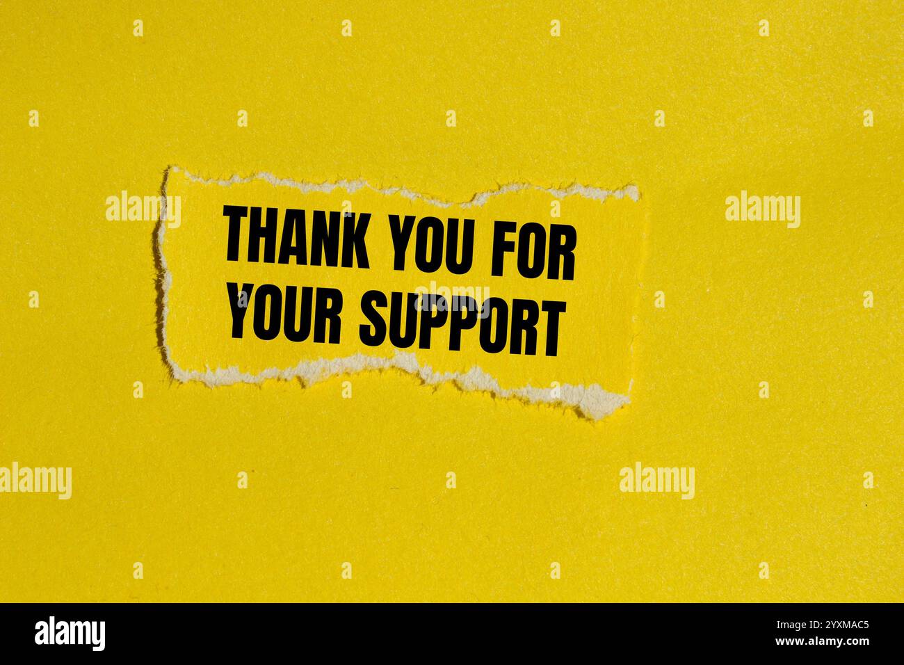 Thank you for your support message written on ripped yellow torn paper ...