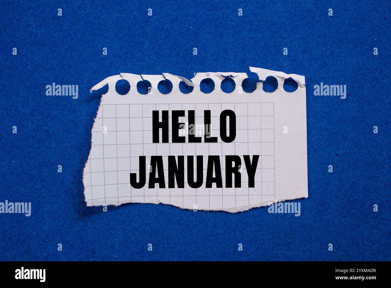 Hello january message written on ripped torn paper piece with blue ...