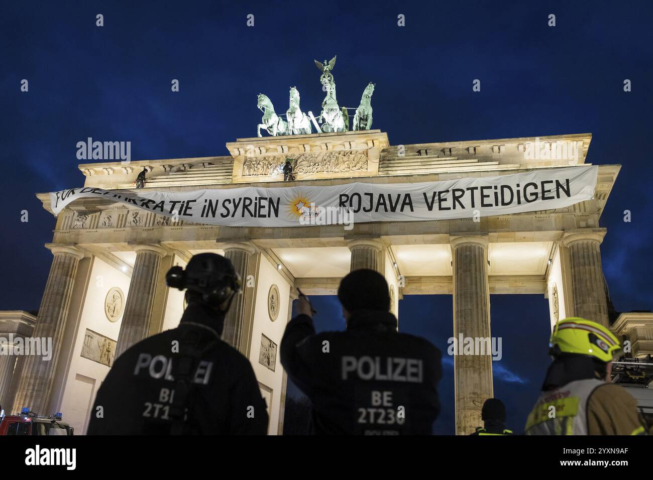 Police officers from the High Altitude Rescue Team remove a banner with ...