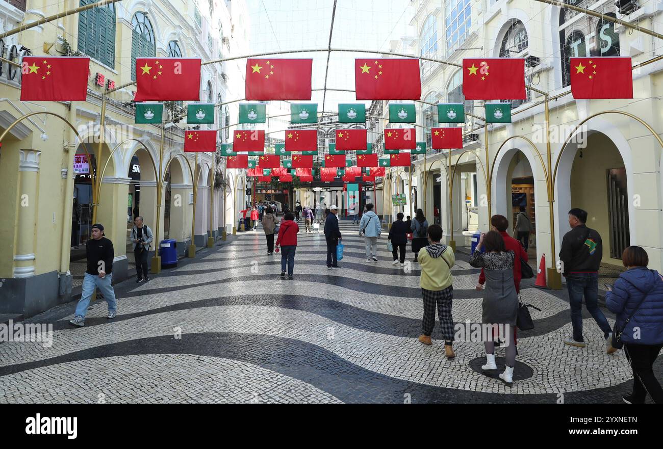 Macao, China. 17th Dec, 2024. People visit a tourist attraction in Macao, south China, Dec. 17, 2024. The streets of Macao have been adorned by festive decorations, as the city is set to mark the 25th anniversary of its return to the motherland. Credit: Yao Qilin/Xinhua/Alamy Live News Stock Photo