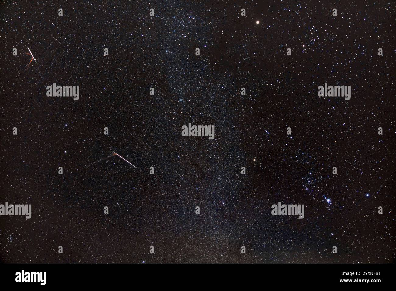 The Geminid meteor shower of 2022, showing two bright Geminids. Stock Photo