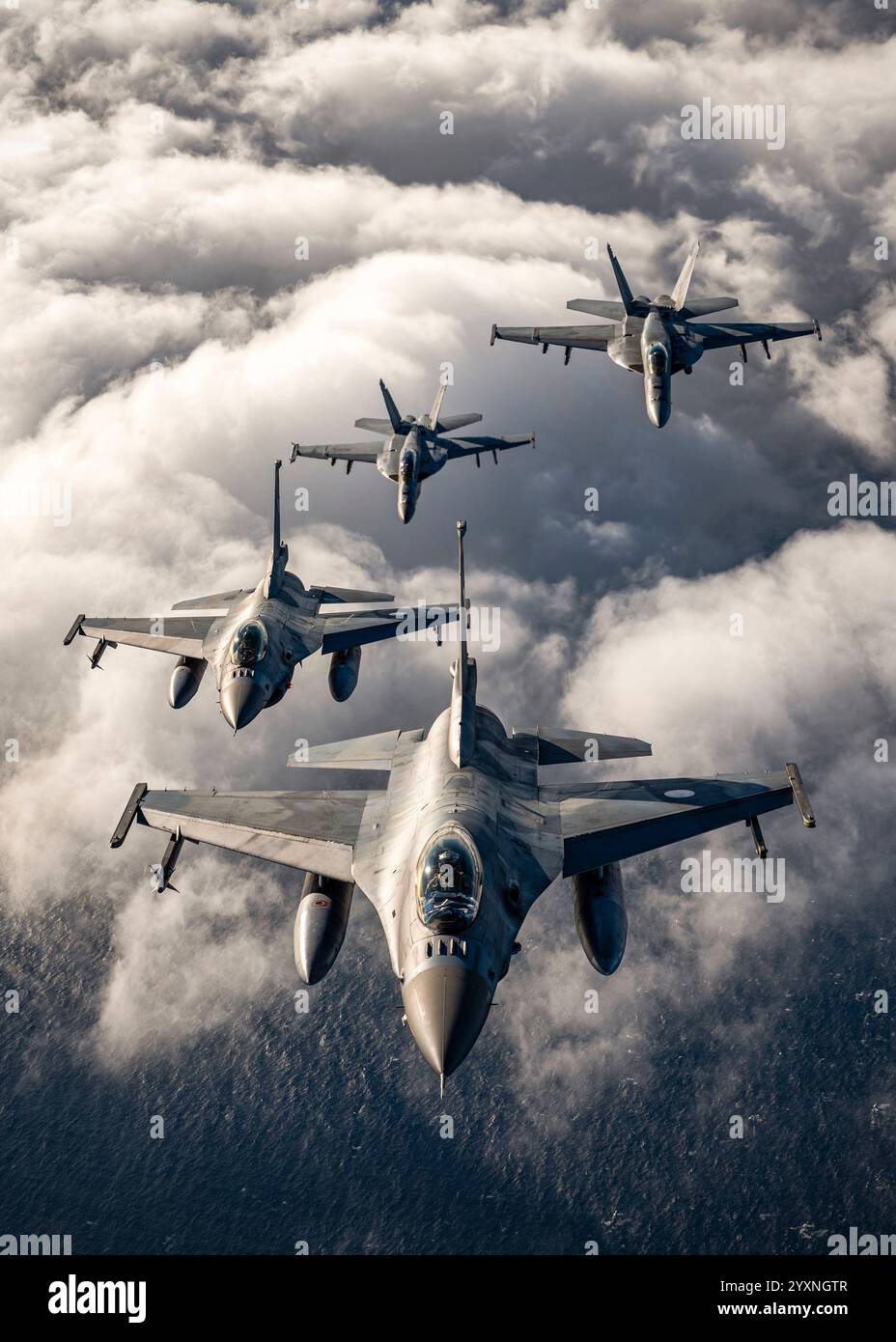 F/A-18 Super Hornets of the U.S. Navy and Hellenic Air Force F-16's fly in formation. Stock Photo