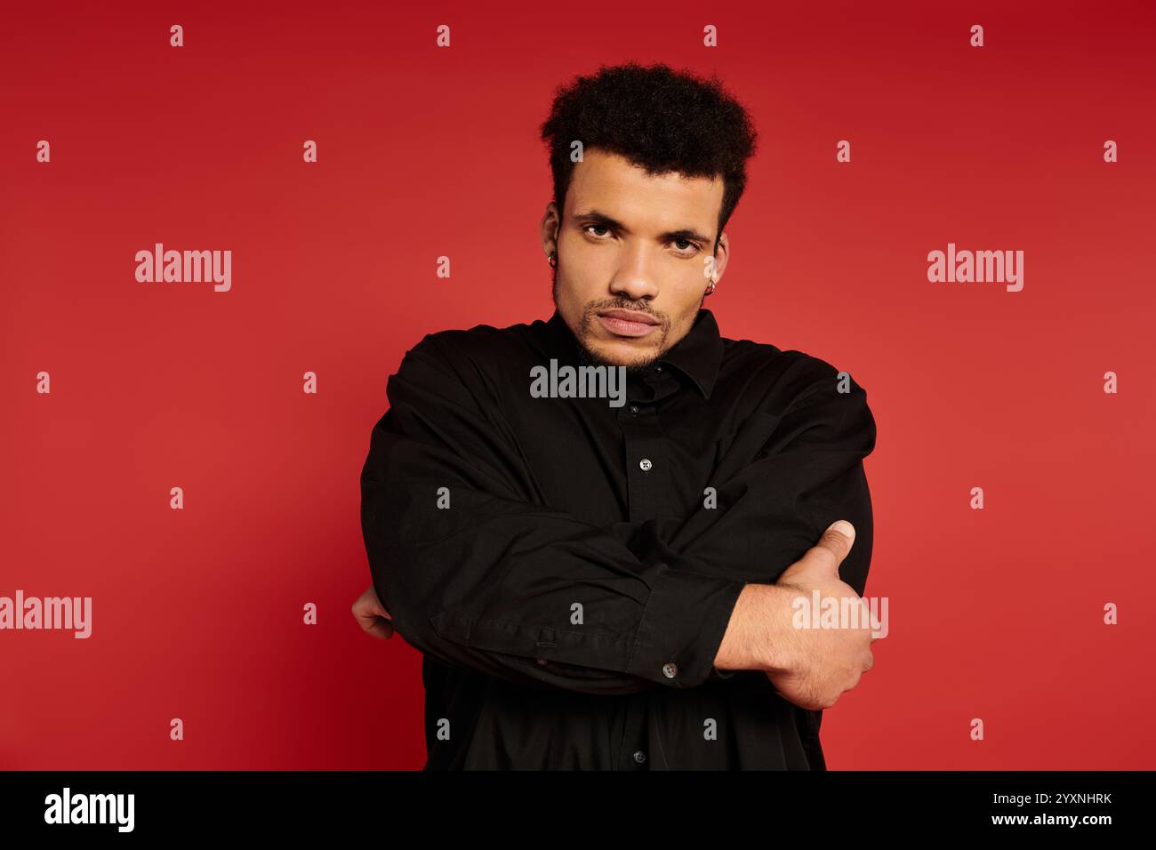 Confident young man stands arms hi-res stock photography and images - Alamy