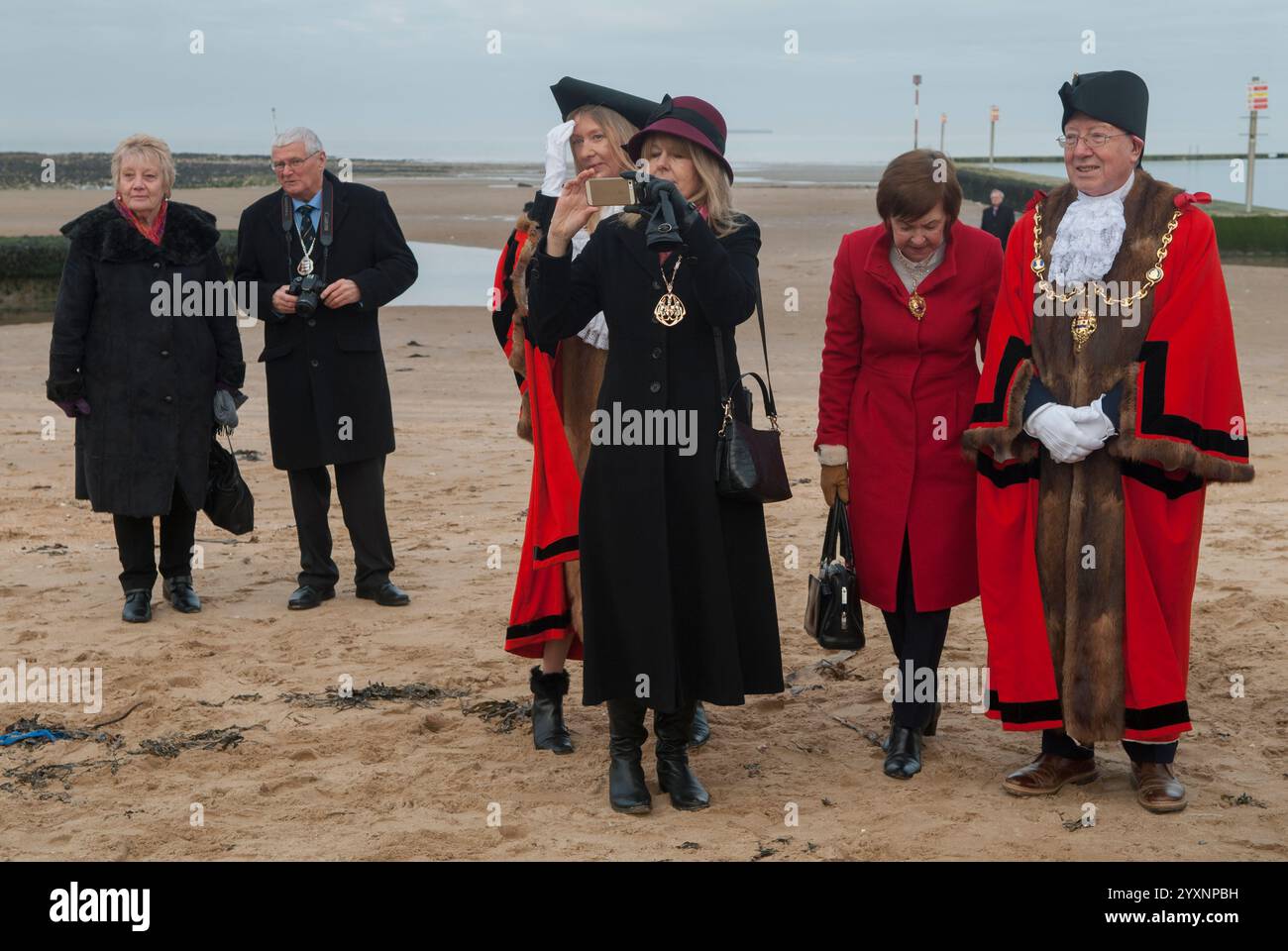 Mayors of Kent and town hall officials after at the Blessing the Sea ceremony Margate beach after the Epiphany - 6th January annual ceremony marking the baptism of Christ. Woman taking a selfie. Margate, Kent, England 8th January 2017. 2010s UK HOMER SYKES Stock Photo