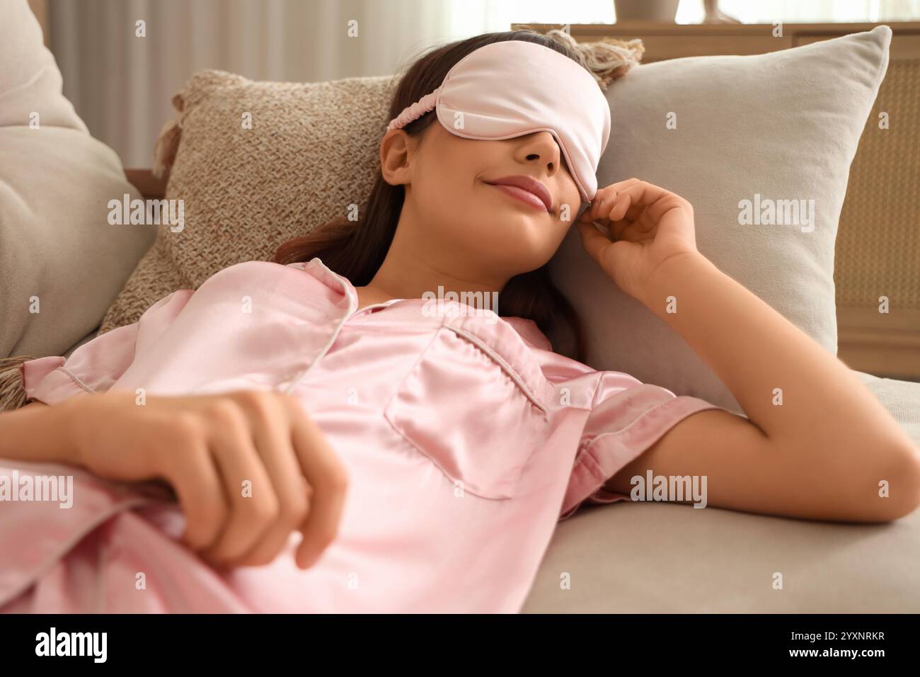 Beautiful young happy woman in pajamas sleeping on sofa at home Stock ...
