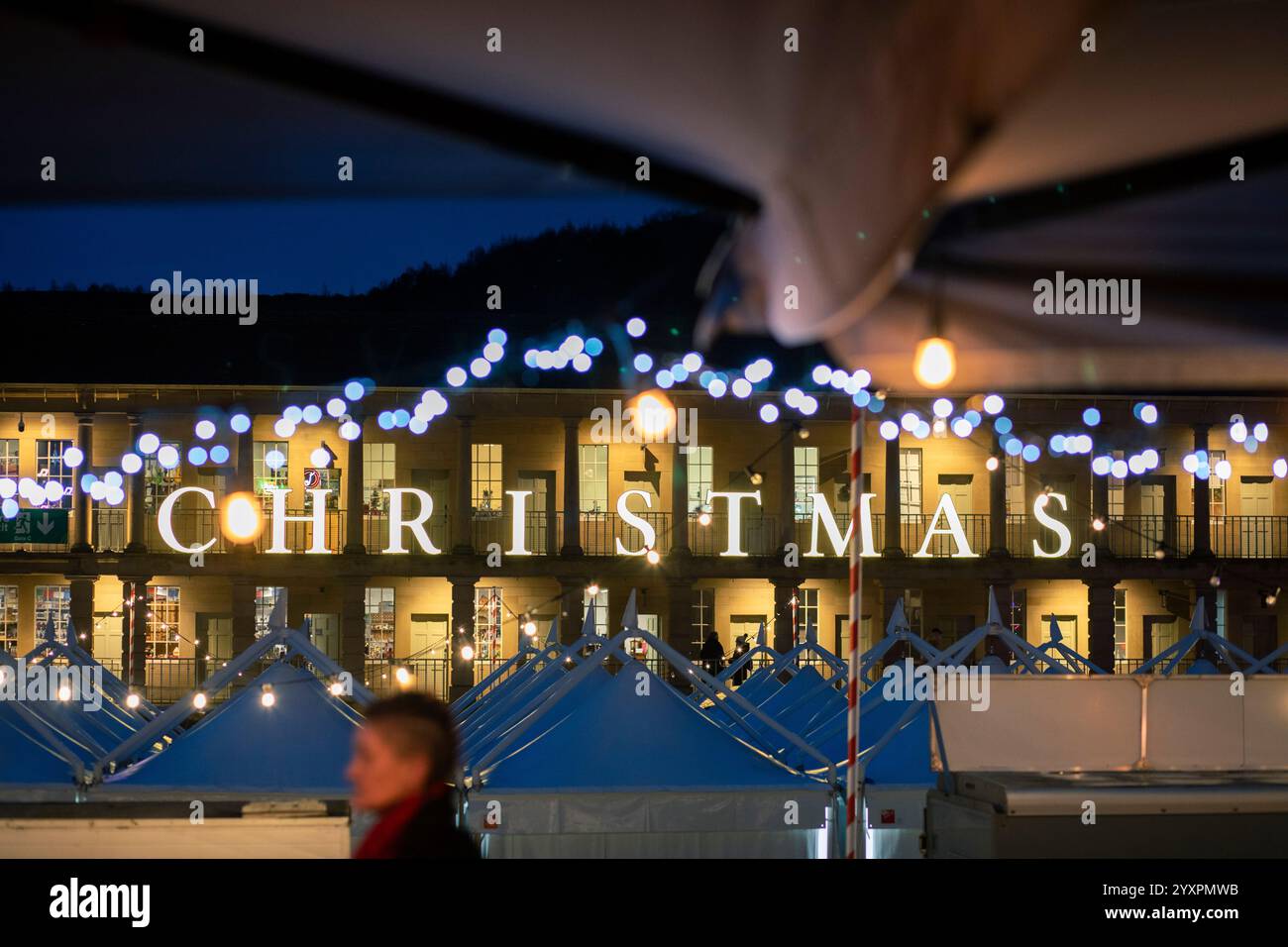 Christmas lights and views of the iconic Piece Hall, Halifax, West Yorkshire, UK. The Piece Hall is a Grade I listed building in Halifax, West Yorkshire, England. It was built as a cloth hall for handloom weavers to sell the woollen cloth 'pieces' they had produced. It has over recent years become popular as a venue for music. Stock Photo