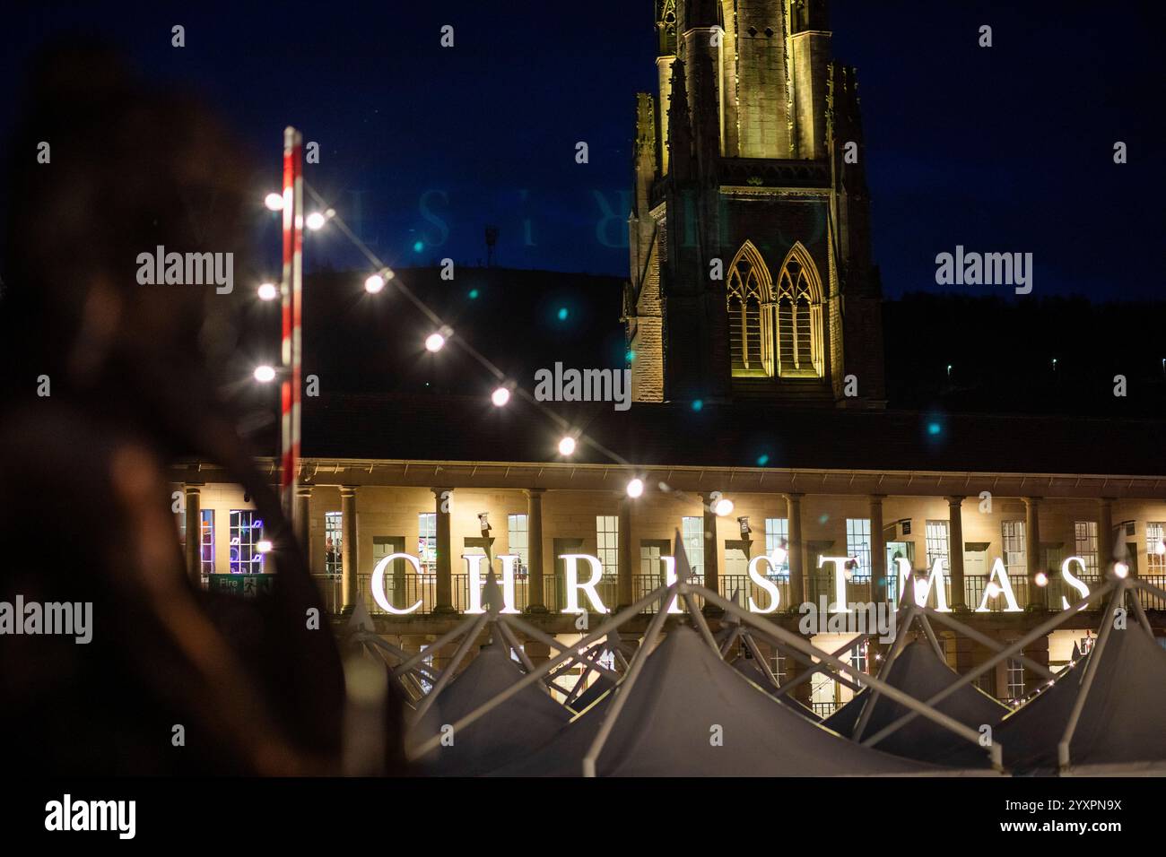 Christmas lights and views of the iconic Piece Hall, Halifax, West Yorkshire, UK. The Piece Hall is a Grade I listed building in Halifax, West Yorkshire, England. It was built as a cloth hall for handloom weavers to sell the woollen cloth 'pieces' they had produced. It has over recent years become popular as a venue for music. Stock Photo