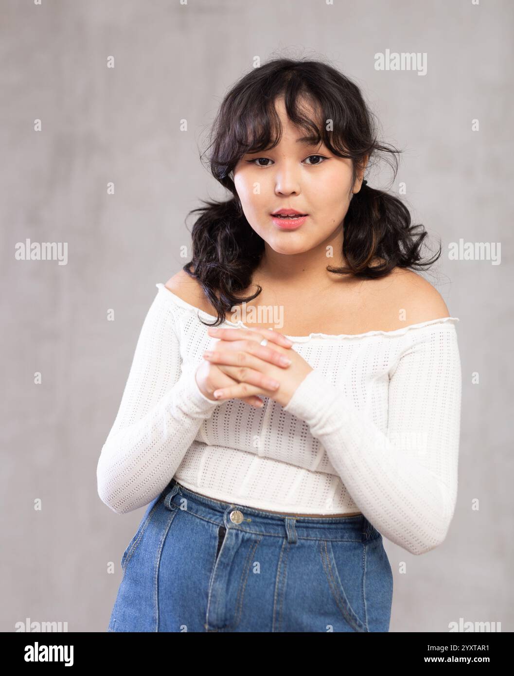 Portrait of surprised young girl posing in studio Stock Photo - Alamy