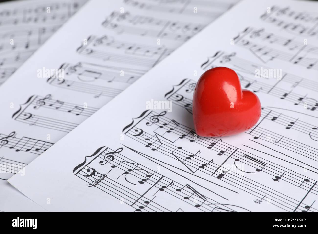 Heart figure on musical note sheets, closeup Stock Photo