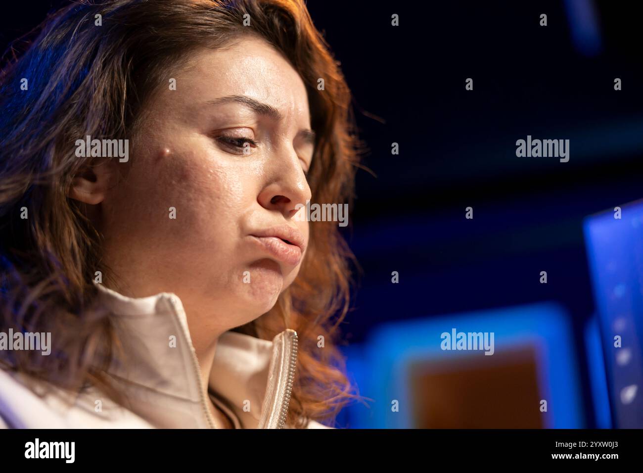Programmer pouting in frustration while doing software quality assurance, finding major errors in source code. Close up of annoyed engineer upset after inspecting coding on PC and seeing many issues Stock Photo