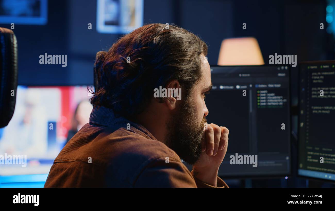 Developer overthinking solutions while doing programming during remote job shift in home office. IT admin working on computer in apartment late at night, thinking how to fix bugs, camera A close up Stock Photo