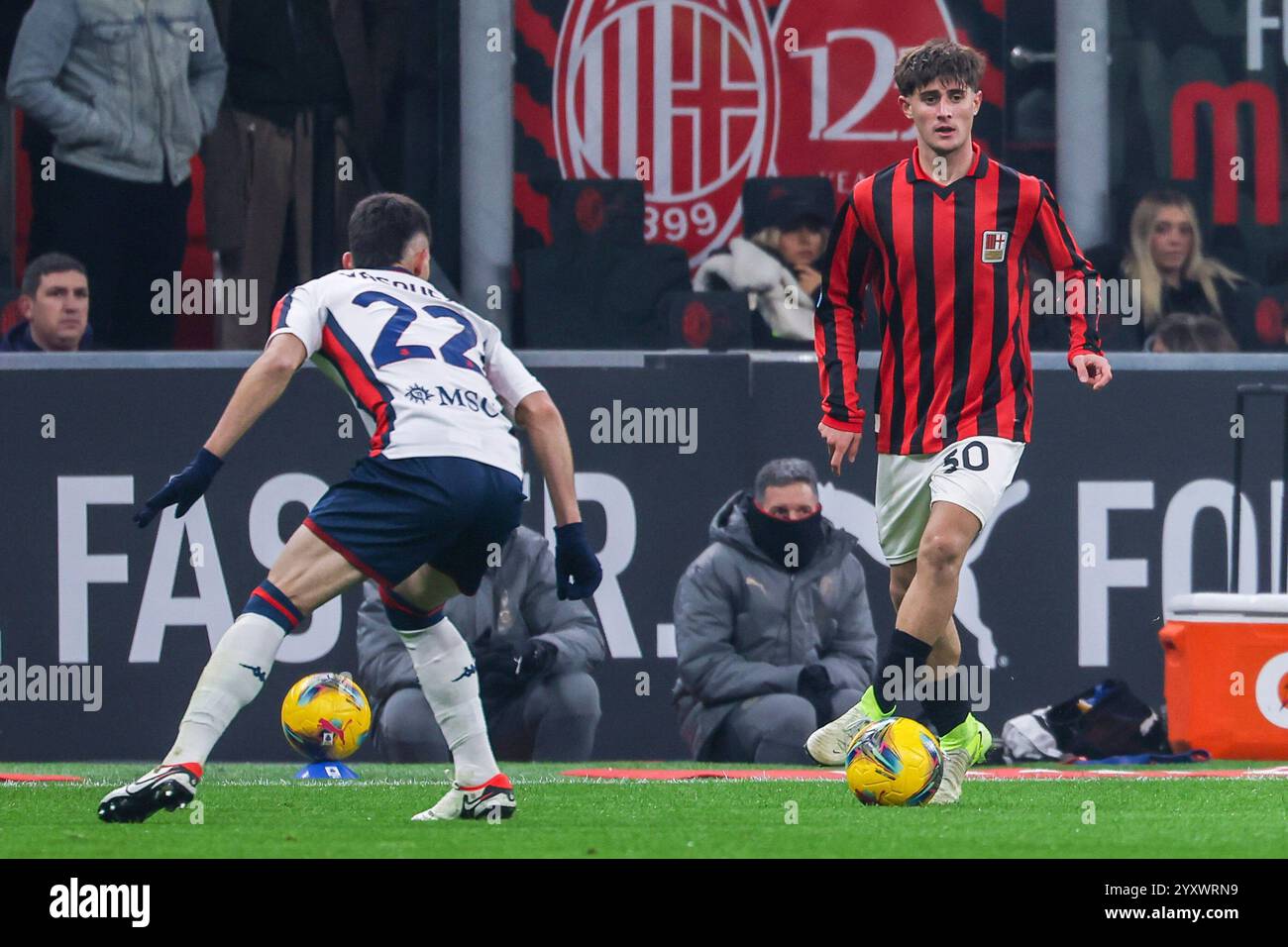 Milan, Italien. 15th Dec, 2024. (R-L) Mattia Liberali of AC Milan with AC Milan 125th Anniversary Jersey and Johan Vasquez of Genoa CFC seen in action during Serie A 2024/25 football match between AC Milan and Genoa CFC at San Siro Stadium Credit: dpa/Alamy Live News Stock Photo