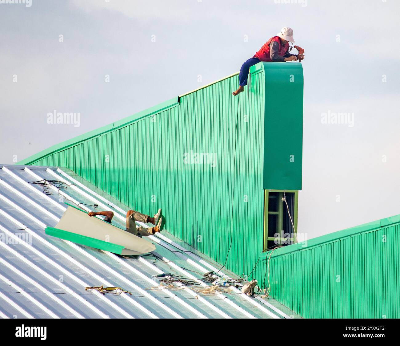 A worker fell while working on the roof of the hall Stock Photo