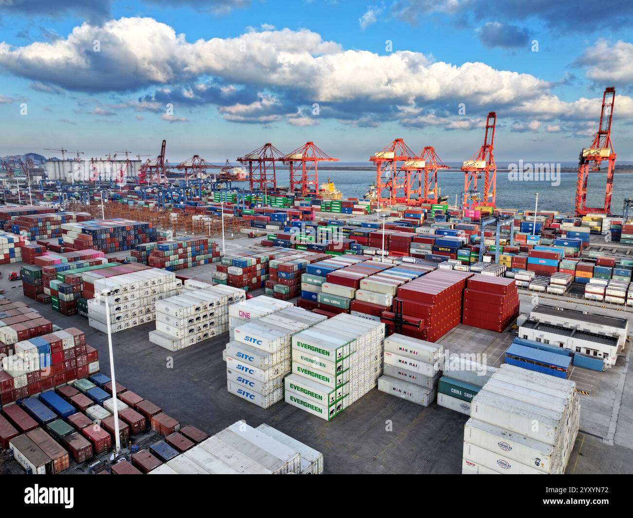 LIANYUNGANG, CHINA - DECEMBER 18, 2024 - Cargo ships stop at their ...
