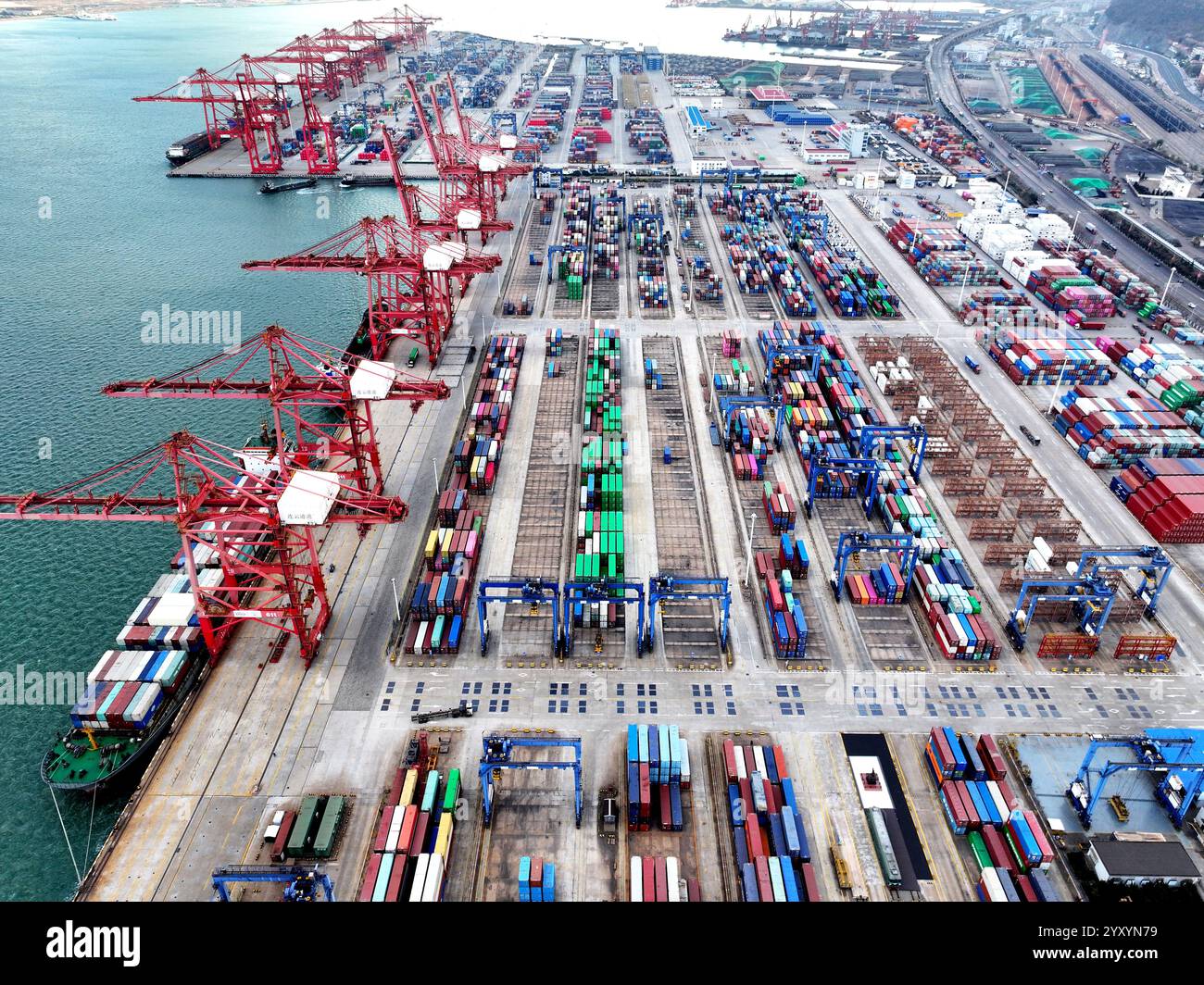 LIANYUNGANG, CHINA - DECEMBER 18, 2024 - Cargo ships stop at their ... image.