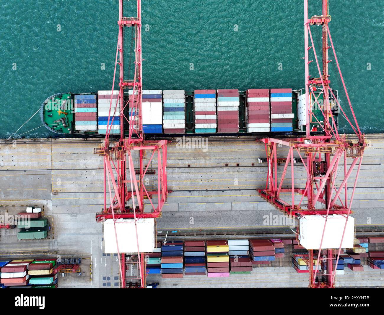 LIANYUNGANG, CHINA - DECEMBER 18, 2024 - Cargo ships stop at their ...