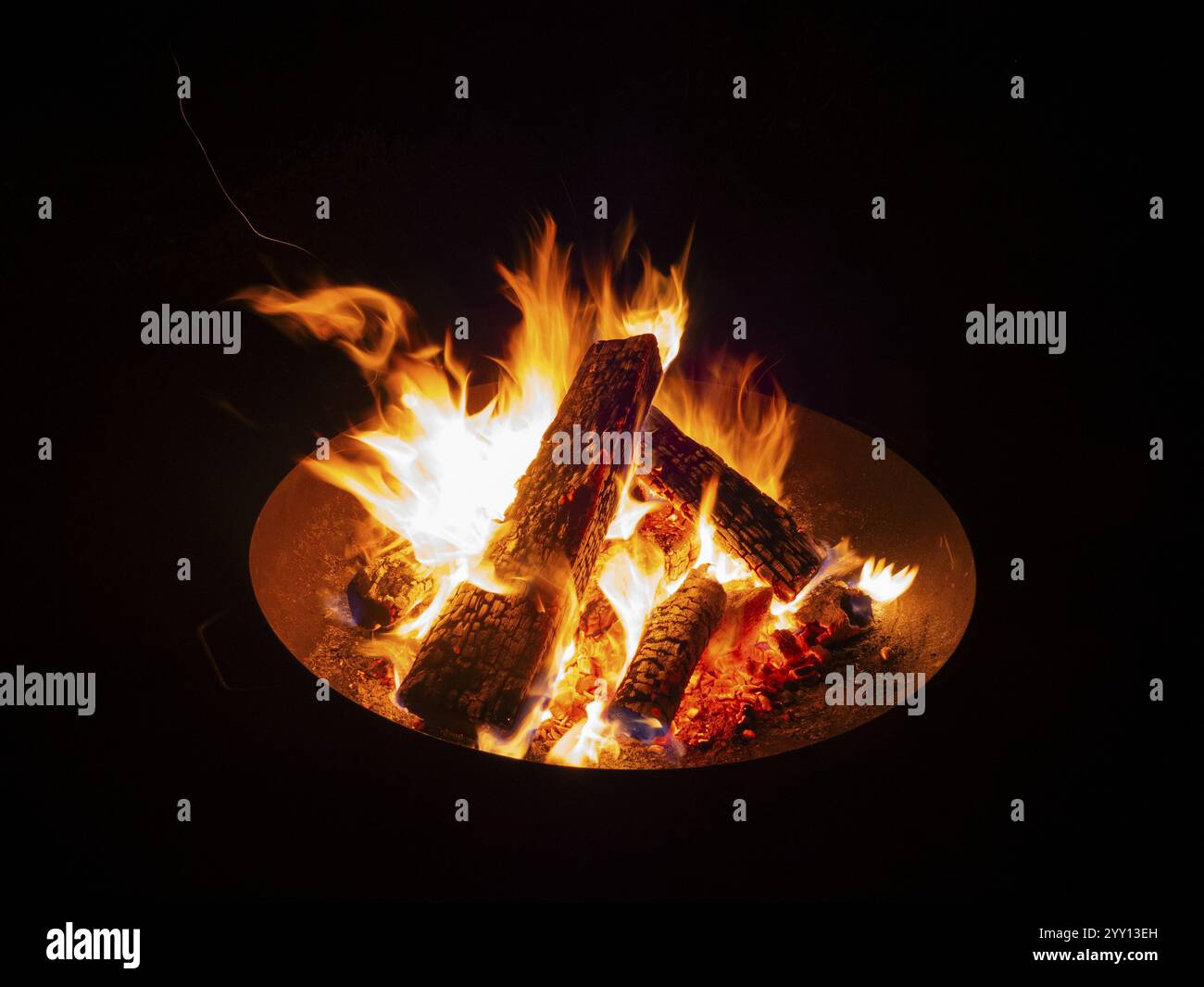 Garden Barbecue Pan, filled with burning wood, creating flames and sparks against the nighttime surroundings, North Hesse, Germany, Europe Stock Photo