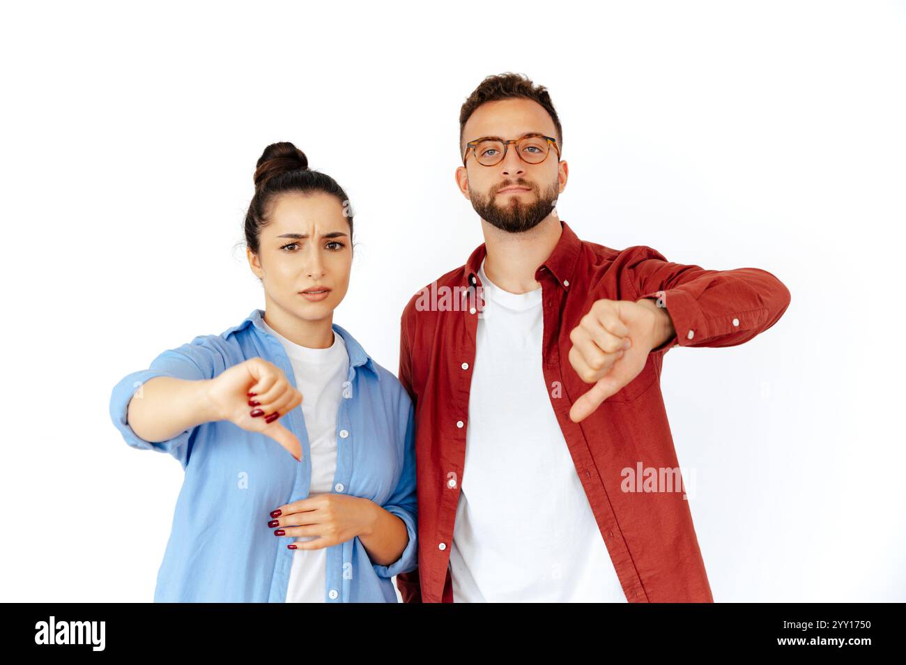 Displeased arabian man and caucasian woman showing thumbs down ...