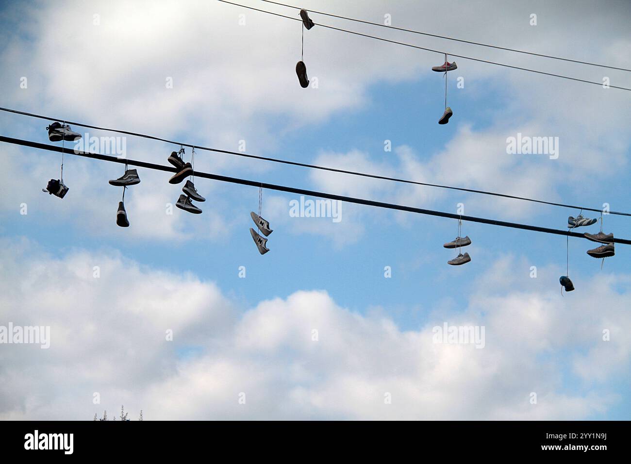 Hanigng Line New York City, USA. Numerous pairs of athletic shoes hanging from the ...