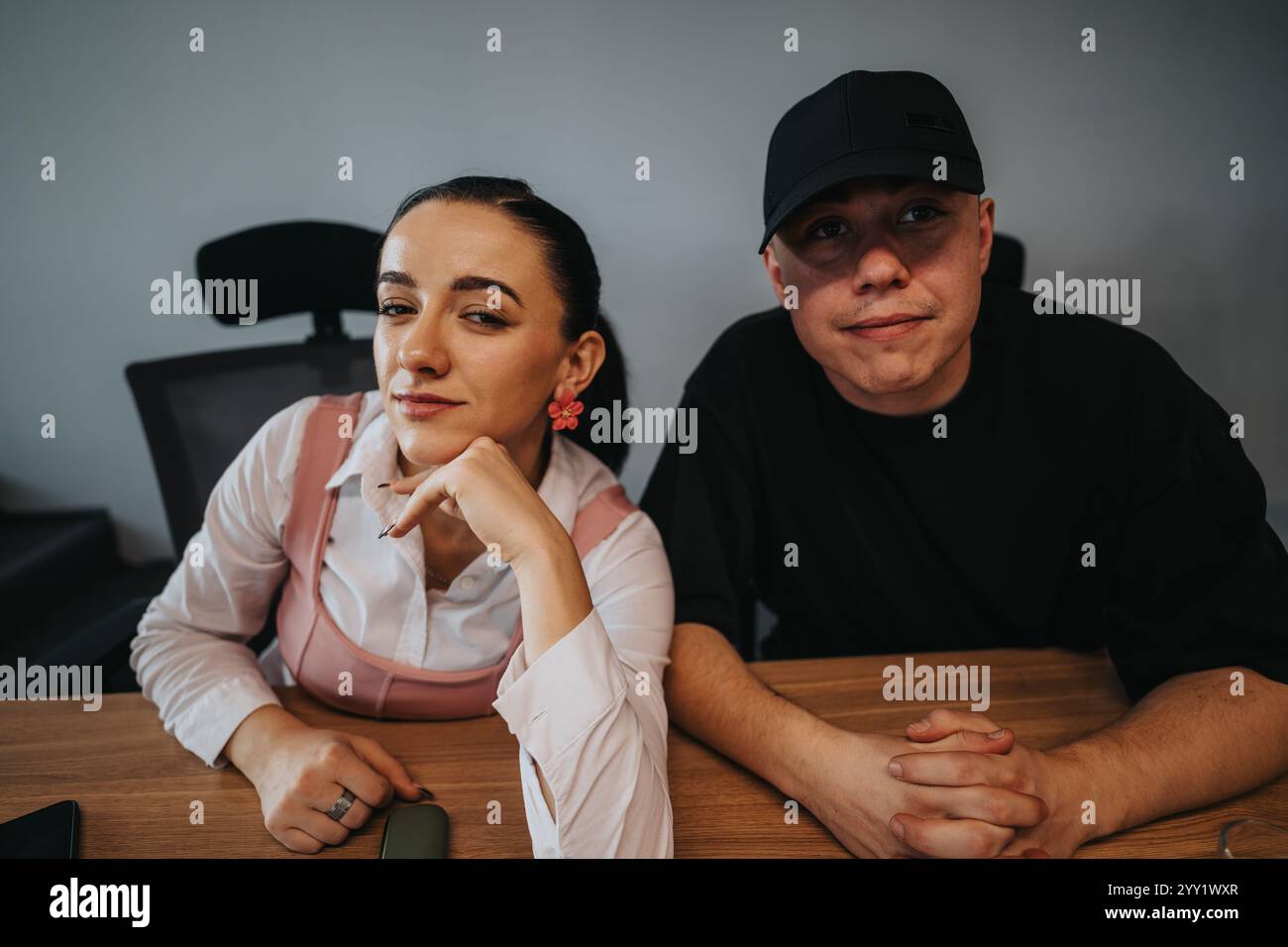 Young professionals collaborating on a project in a modern office setting Stock Photo