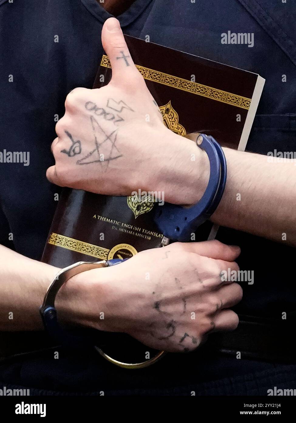 Robert E Crimo III holds the Quran in English in court before Judge Robert E Crimo III holds the Quran in English in court before Judge