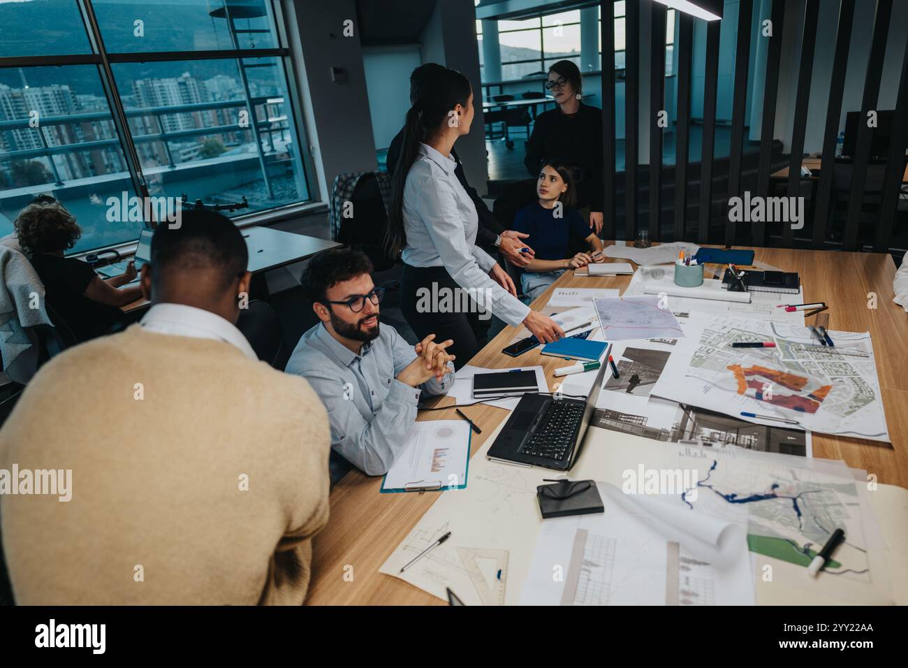 Multicultural team brainstorming ideas in modern office setting Stock ...