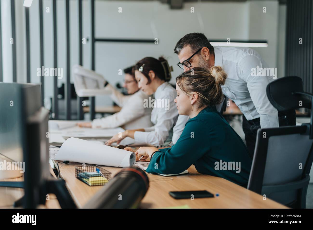 Multicultural team collaborating on a project in modern office Stock Photo