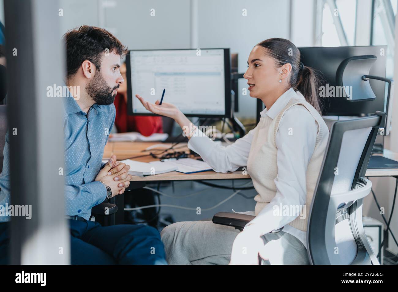Professional discussion between two colleagues in modern office environment Stock Photo