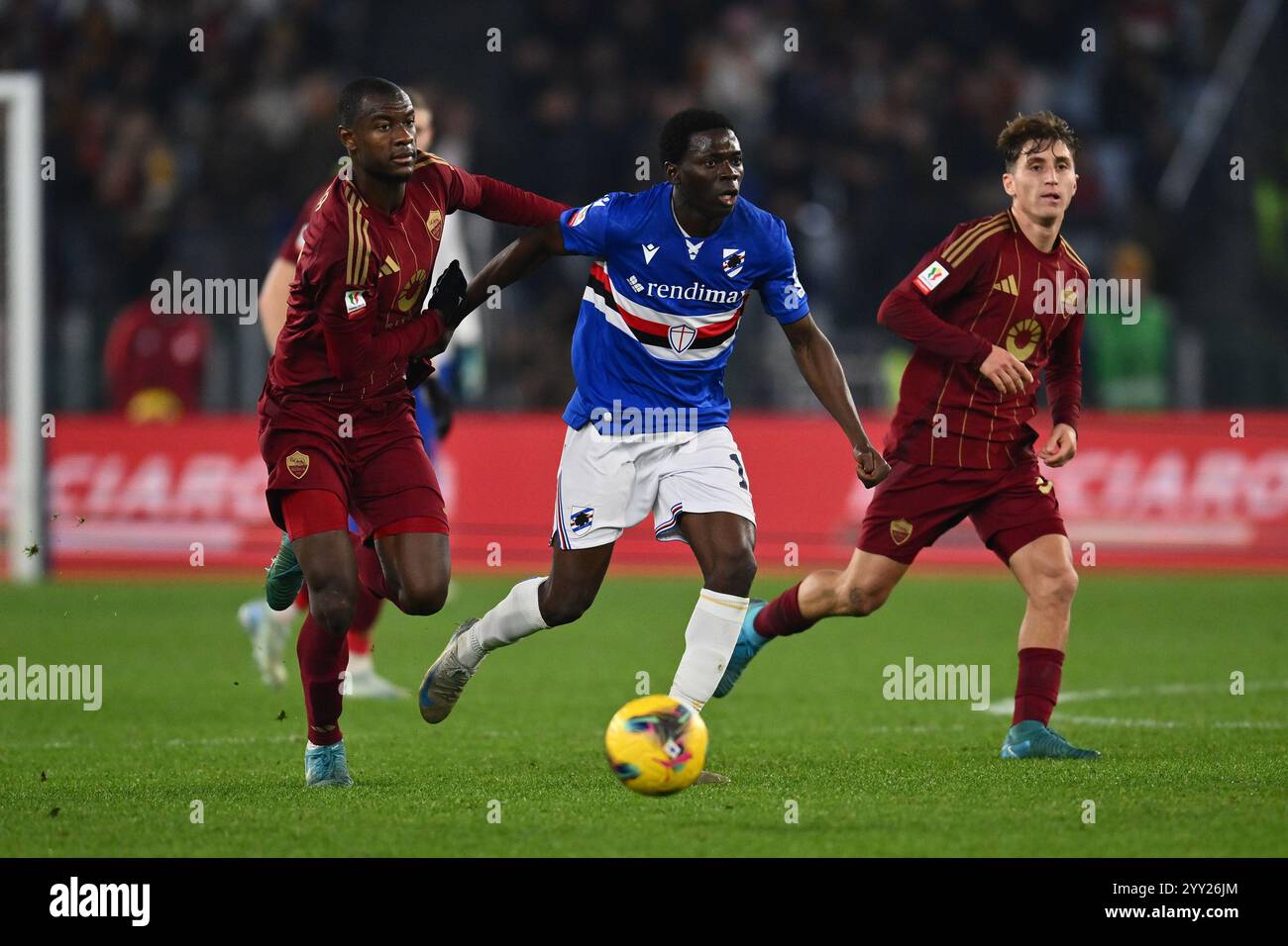 Rome, Italy. 18th Dec, 2024. Evan Ndicka of A.S. Roma and Ebenezer Akinsanmiro of U.C. Sampdoria in action during the Frecciarossa Italian Cup round of 16 match between A.S. Roma and U.C. Sampdoria at the Olympic Stadium on December 18, 2024 in Rome, Italy. Credit: Independent Photo Agency/Alamy Live News Stock Photo