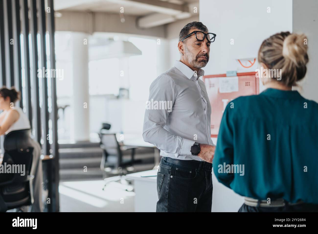 Professional interaction between colleagues in modern office setting Stock Photo