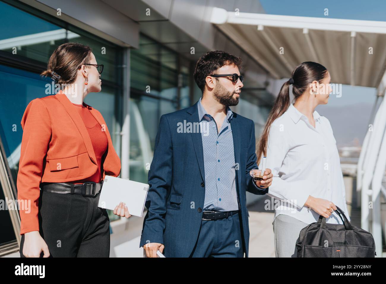 Business people walking outside modern office building Stock Photo - Alamy