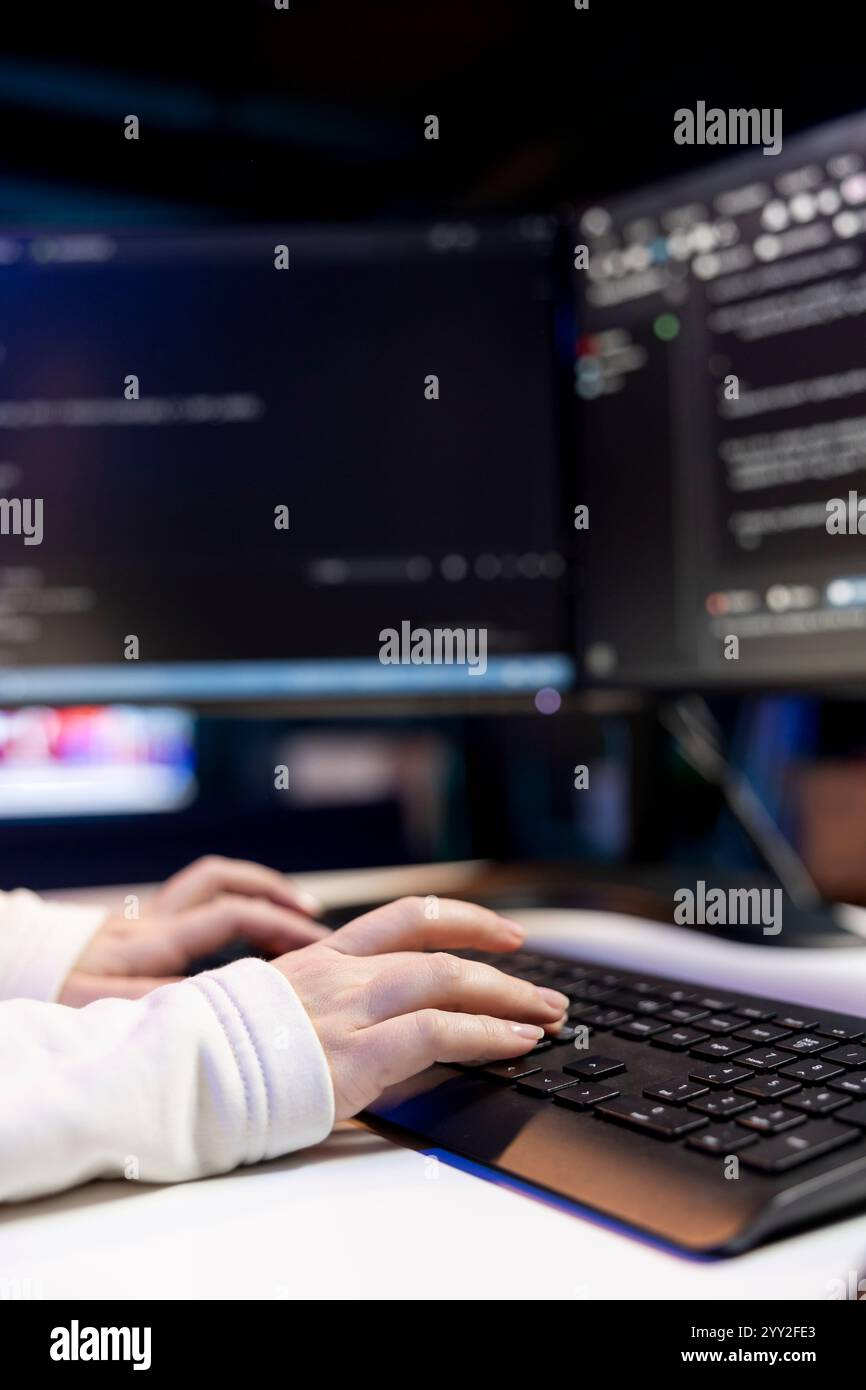 Woman typing on keyboard, implementing security measures to protect company systems and data. Close up shot of IT specialist writing, testing and debugging Java code for software applications, Stock Photo