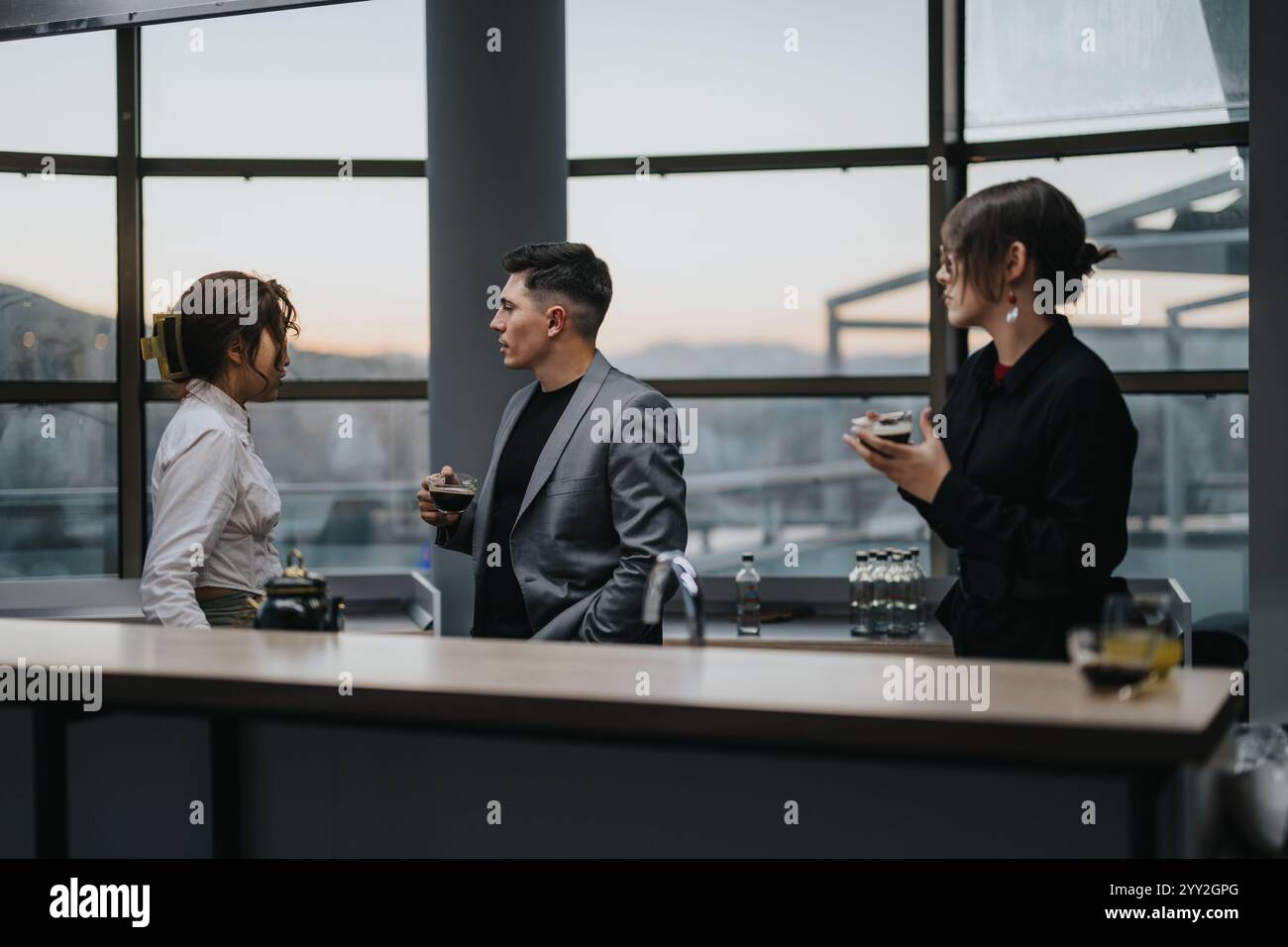 Business professionals having a coffee break in a modern workspace ...