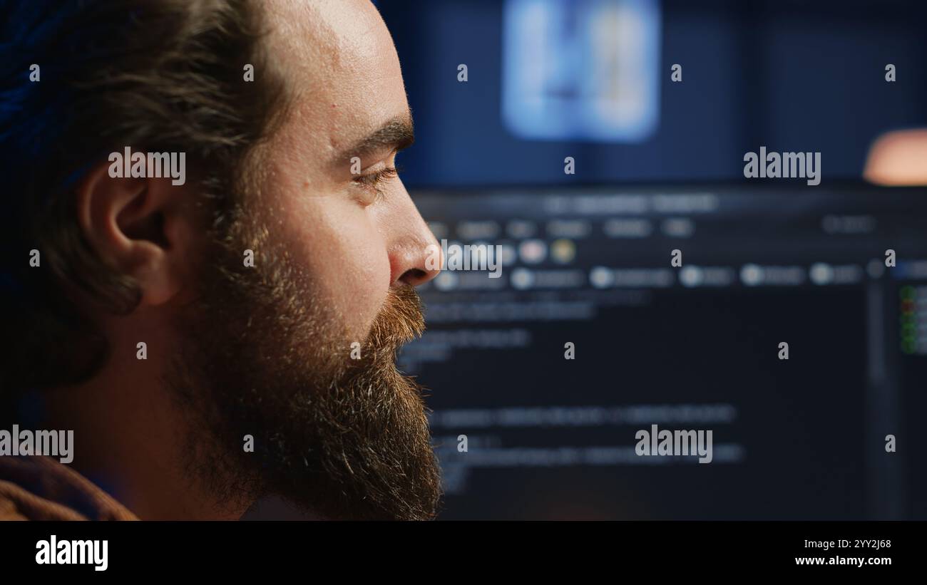 Happy software engineer feeling satisfied after removing all bugs while coding on computer, close up. Joyous IT admin looking at PC screen, pleased after solving script errors, camera A close up Stock Photo