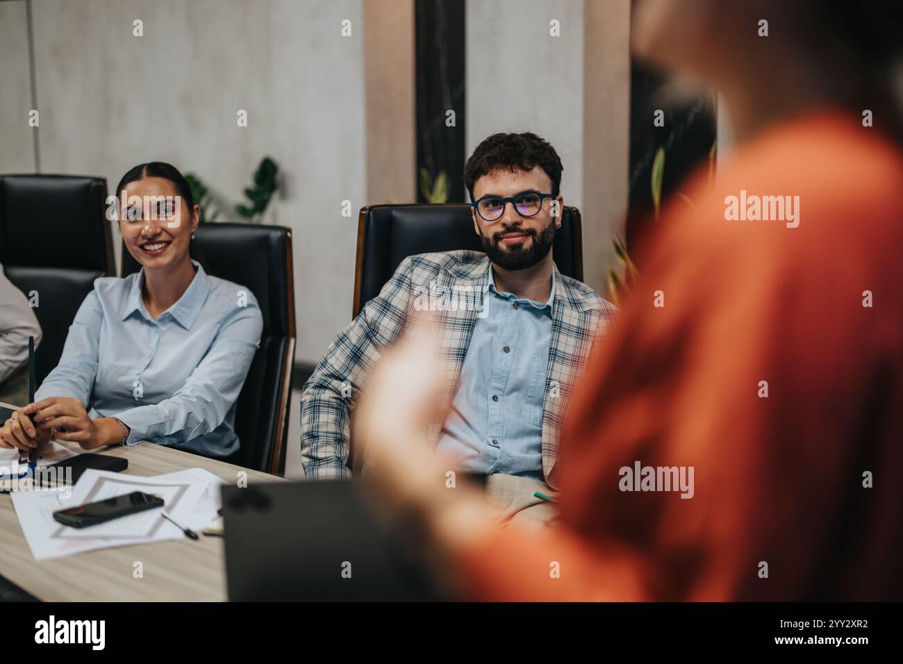 A diverse group of colleagues engage in a nighttime business meeting ...