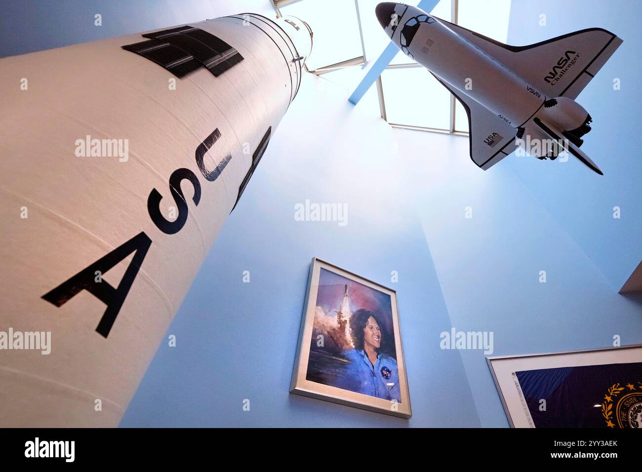 A model of the space shuttle Challenger, at right, floats above a ...