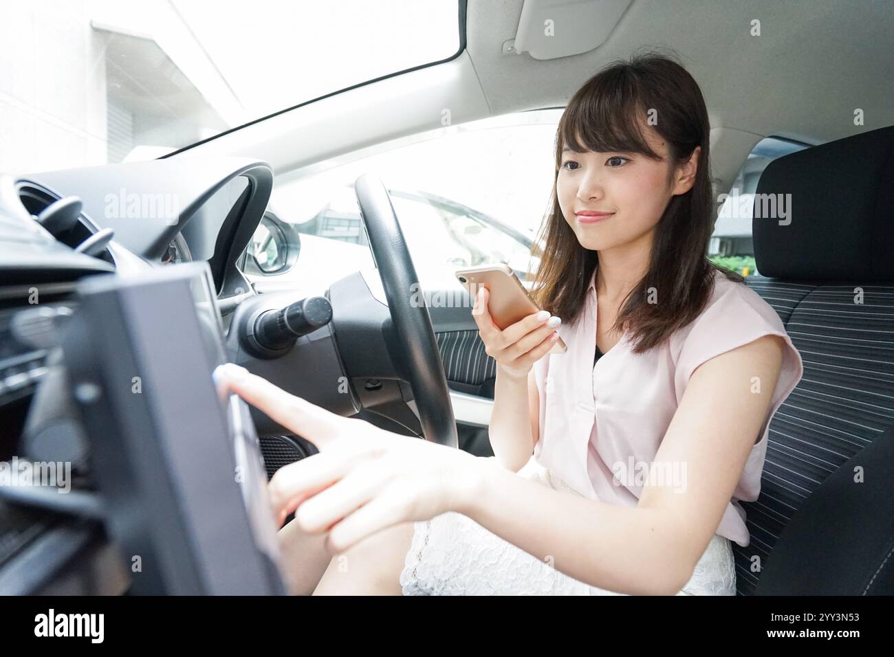 Woman using car navigation system Stock Photo - Alamy