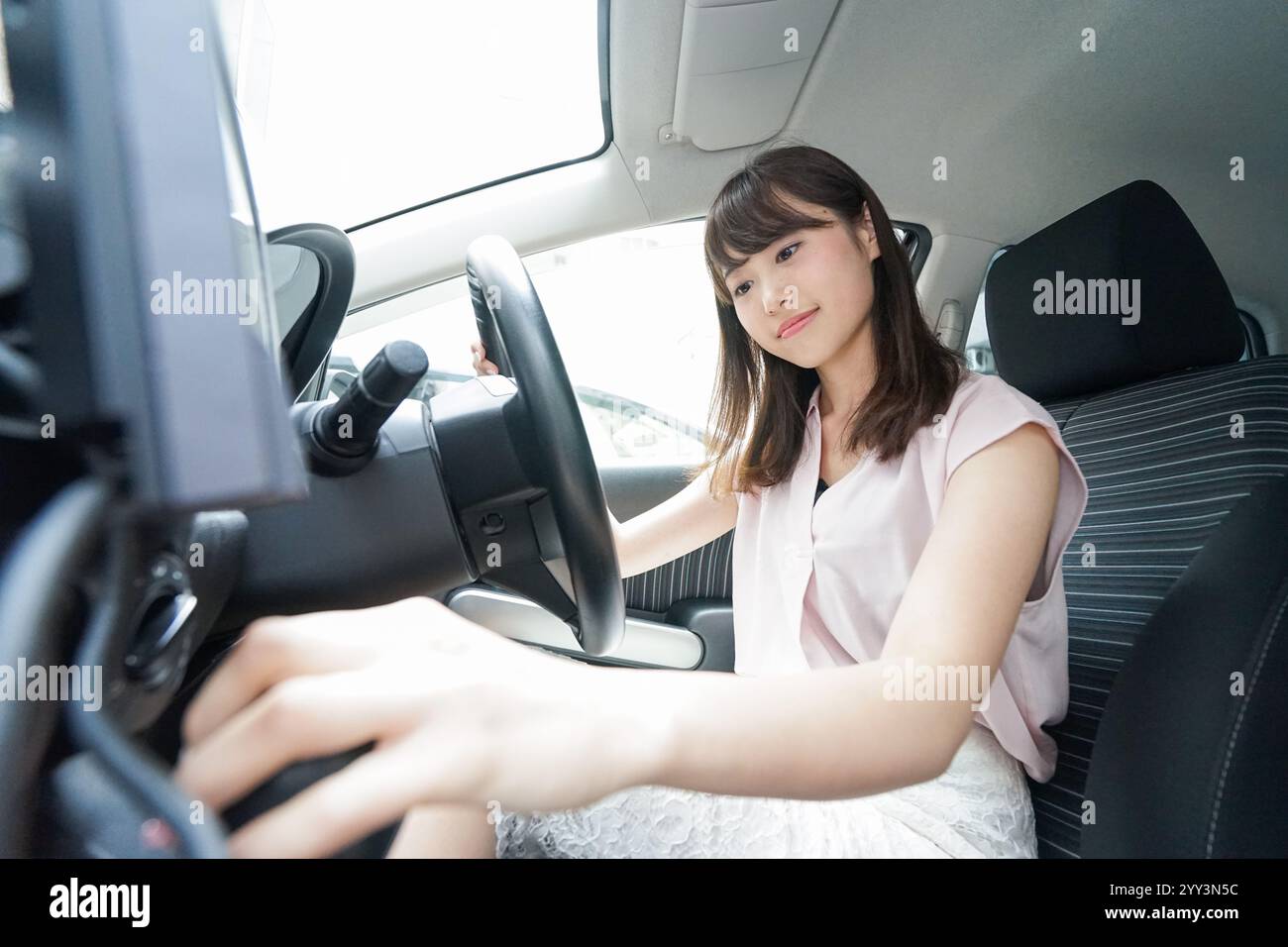 Woman using car navigation system Stock Photo