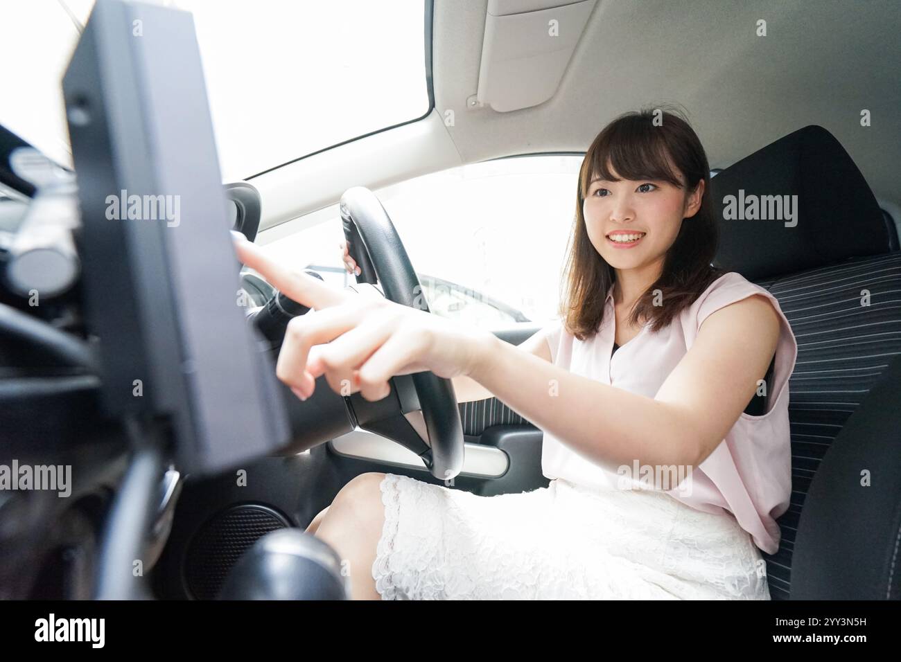 Woman using car navigation system Stock Photo
