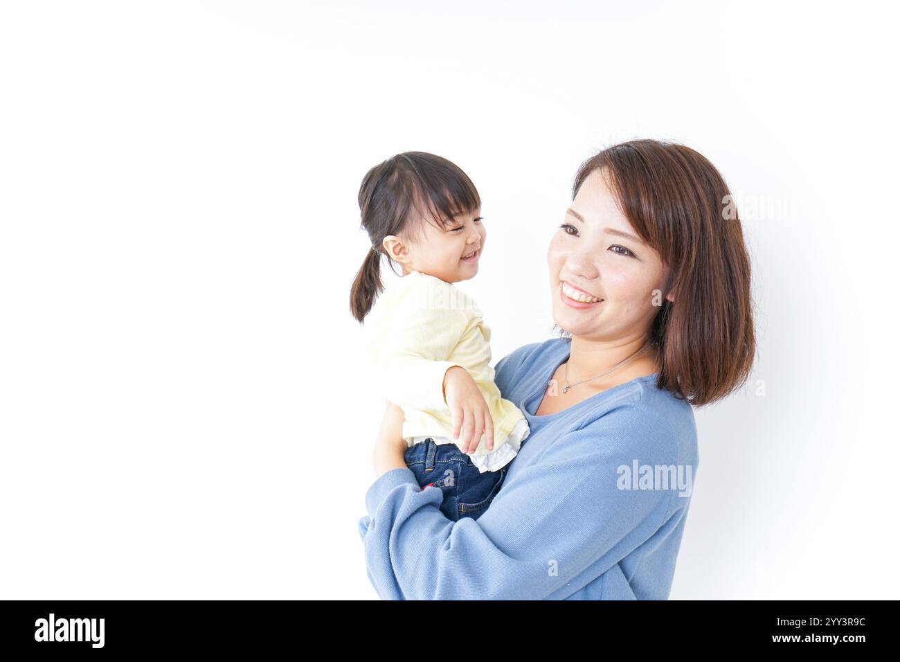 Mother carrying her child Stock Photo