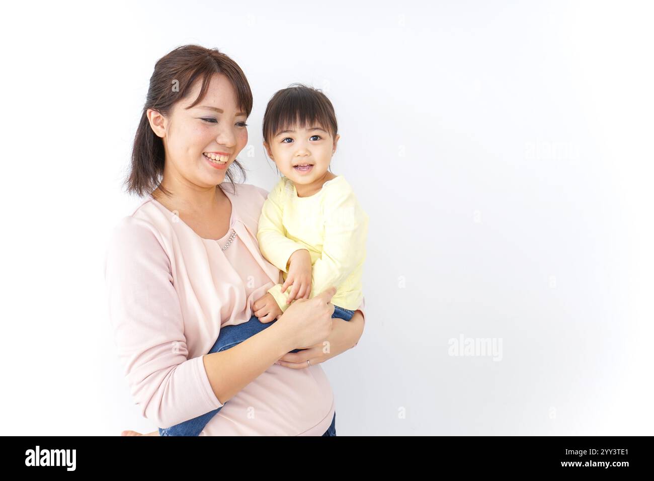 Mother carrying her child Stock Photo