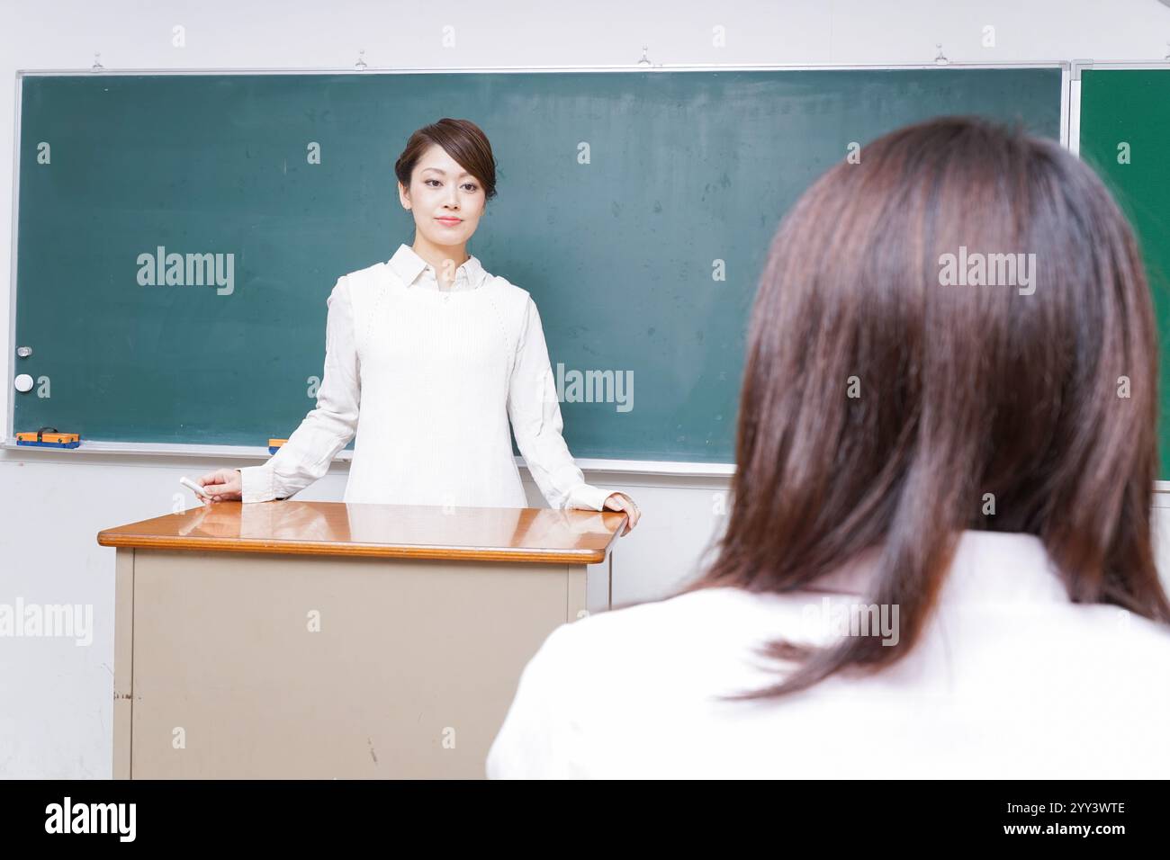 Teacher giving a lesson at school Stock Photo - Alamy